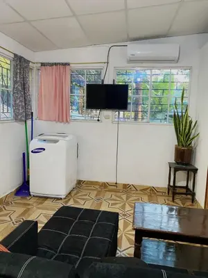 a living room with a couch and a flat screen tv at Aguiñada's house en el Rosario La Paz in El Rosario