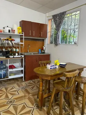 a kitchen with a wooden table and chairs at Aguiñada's house en el Rosario La Paz in El Rosario