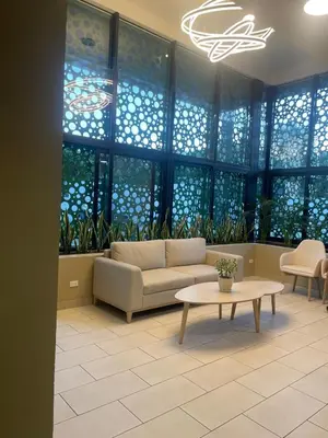 a living room with a couch and a table and windows at Cozy apartment with panoramic view in San Salvador