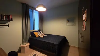 a small bedroom with a bed and a window at Habitación en casa de Diana in San Salvador