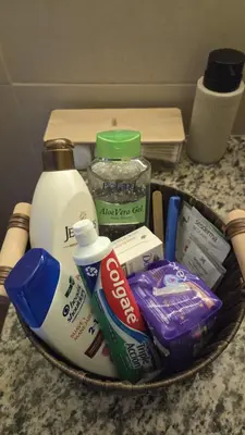 a basket filled with toiletries and other items on a counter at Habitación en casa de Diana in San Salvador