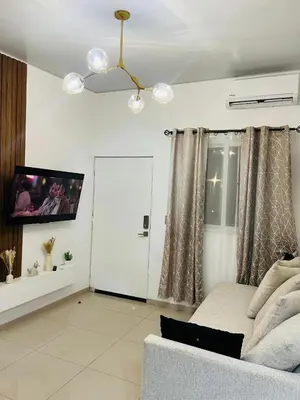 a living room with a couch and a tv and a door at Exclusivo y céntrico en San Miguel in San Miguel