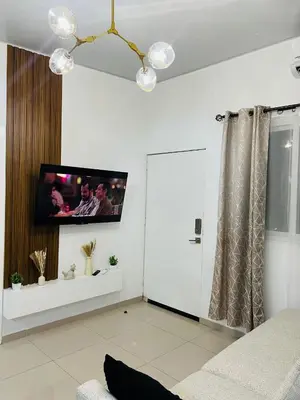 a living room with a tv on the wall at Exclusivo y céntrico en San Miguel in San Miguel