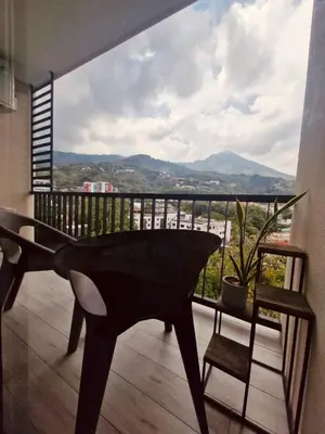 a black piano sitting on a balcony with a view at Beautiful City & Volcano Views in San Salvador