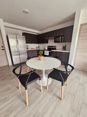 a white table and two chairs in a kitchen at Beautiful City & Volcano Views in San Salvador