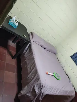 a sleeping bag with a toothbrush on top of it at Kame-House Backpackers in San Salvador