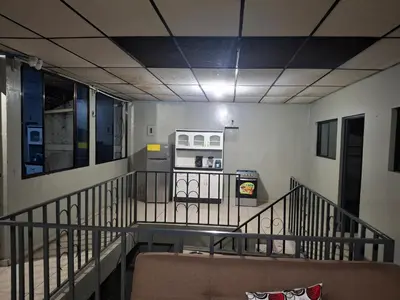 a room with a staircase with a table and a microwave at Apartamento in San Salvador