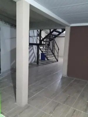 an empty room with a staircase in a building at Casa de Huéspedes Noche de Luna in San Salvador