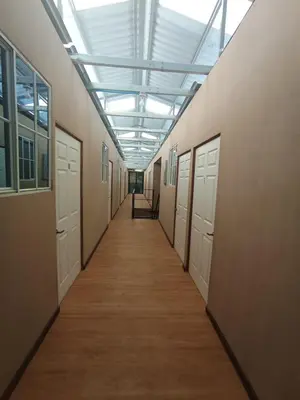 a hallway with white doors and a ceiling at Casa de Huéspedes Noche de Luna in San Salvador