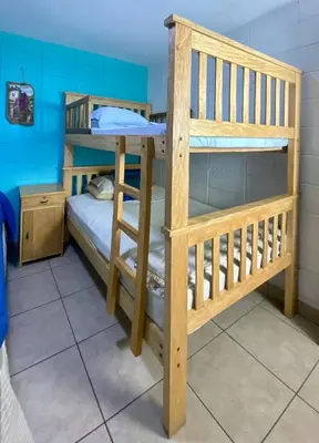a couple of bunk beds in a room at Mangomar Beach House in Teotepeque