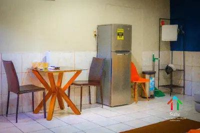 a kitchen with a table and chairs and a refrigerator at Suite 608 Ciudad Jardín San Miguel in San Miguel