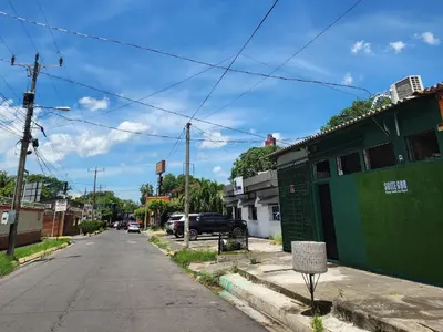 an empty street with a green building on the side at Suite 608 Ciudad Jardín San Miguel in San Miguel