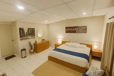 a bedroom with a large bed and a bathroom at Suite 608 Ciudad Jardín San Miguel in San Miguel