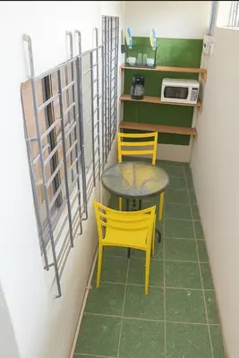 a small table and two yellow chairs in a room at Suite 608 Ciudad Jardín San Miguel in San Miguel