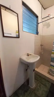 a bathroom with a sink and a shower at Casa Flor Blanca in San Salvador