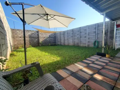 a patio with an umbrella and a chair at Casa del paseante in San Miguel