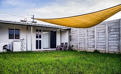 a porch of a house with a hammock in the yard at Casa del paseante in San Miguel