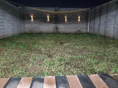 a patio with some grass and lights on it at Casa del paseante in San Miguel