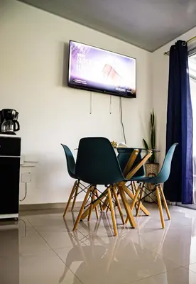 a living room with two chairs and a television on the wall at Casa del paseante in San Miguel