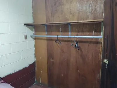 a wooden door with a pair of shoes on it at KameHouse Backpackers in San Salvador