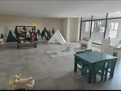 a living room with a table and a dog laying on the floor at Apartamento Nuevo ,Todo a tu alcance in San Salvador