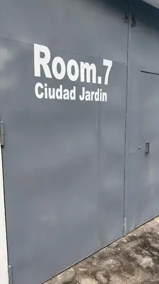 a building with a sign on the side of it at Room 7 Ciudad Jardin in San Miguel