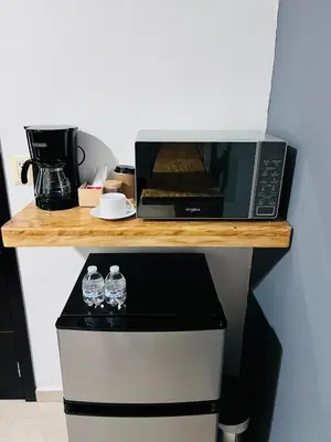 a microwave sitting on top of a wooden counter at Room 7 Ciudad Jardin in San Miguel
