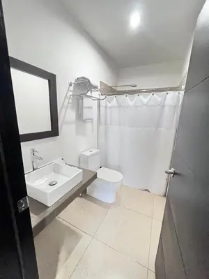 a white bathroom with a sink and a toilet at Room 7 Ciudad Jardin in San Miguel