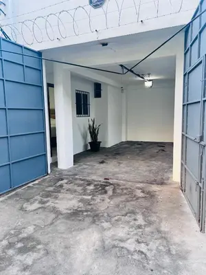 an empty garage with a blue garage door at Room 7 Ciudad Jardin in San Miguel