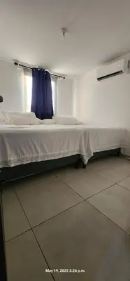 a large bed in a room with a window at La Joya de Opico in San Juan Opico