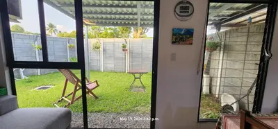 a view of a yard from a room with a window at La Joya de Opico in San Juan Opico