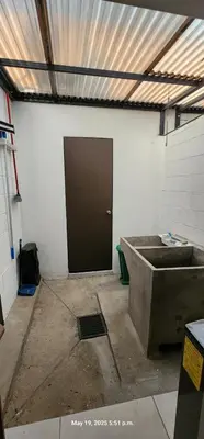 a garage with a door and a room with a cement floor at La Joya de Opico in San Juan Opico