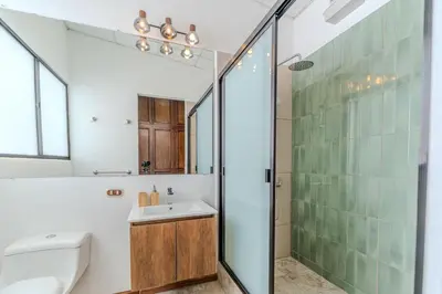 a bathroom with a sink and a shower at Casa Lúmina - Hotel Boutique, San Benito in San Salvador