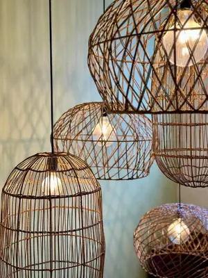 a group of cages hanging from a ceiling with lights at Casa Lúmina - Hotel Boutique, San Benito in San Salvador