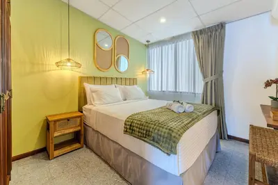 a bedroom with a bed with two towels on it at Casa Lúmina - Hotel Boutique, San Benito in San Salvador