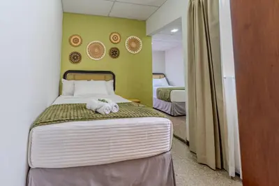 a bedroom with a bed with a stuffed animal on it at Casa Lúmina - Hotel Boutique, San Benito in San Salvador