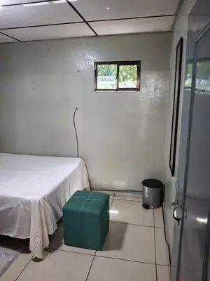 a small room with a bed and a window at Habitación sencilla in San Salvador