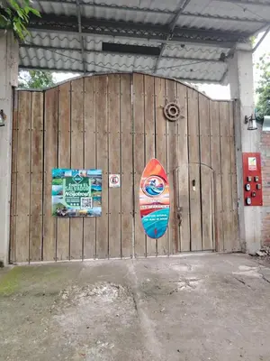 a wooden gate with a surfboard in front of it at Rancho Los Hernandez - Surf City - El Tunco in Tamanique