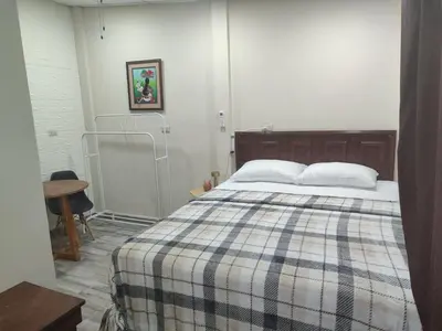a bedroom with a bed with a plaid blanket at Estancia WLC