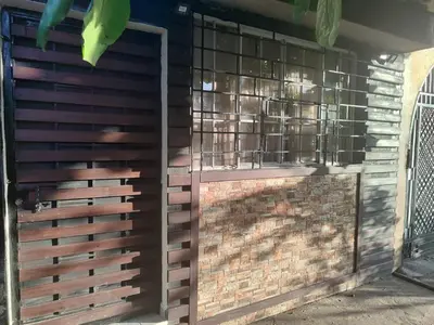 a wooden fence with a gate and a brick wall at Estancia WLC