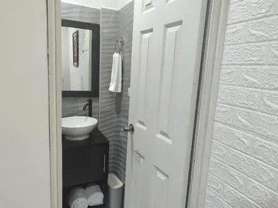 a bathroom with a white sink and a mirror at Estancia WLC