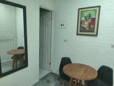 a dining room with two tables and a mirror at Estancia WLC
