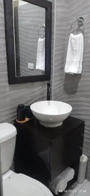 a bathroom with a sink and a toilet and a mirror at Estancia WLC