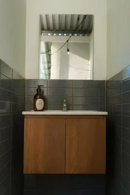a bathroom with a sink and a mirror at Surfside El Tunco in Tamanique