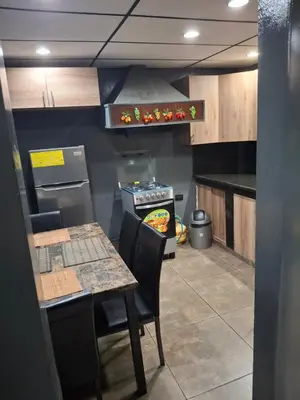 a small kitchen with a table and a stove at Mini apartamento familiar in San Salvador