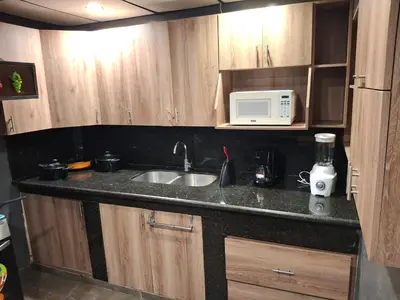 a kitchen counter with a sink and a microwave at Mini apartamento familiar in San Salvador