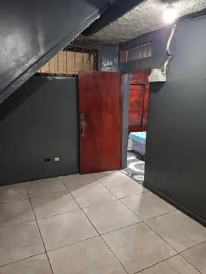 a room with two doors and a tile floor at Mini apartamento familiar in San Salvador