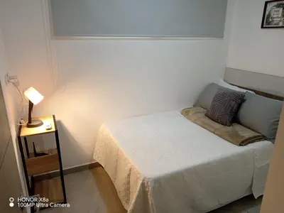 a small bedroom with a bed and a lamp at Un lugar especial en San Salvador in San Salvador