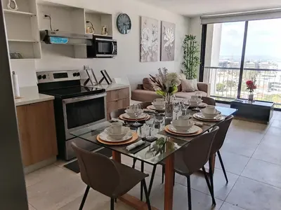 a kitchen and living room with a table and chairs at Un lugar especial en San Salvador in San Salvador