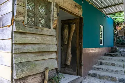 an open door to a house with stairs at Las Cabañitas, el boqueron in San Salvador